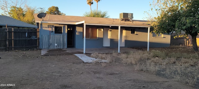 back of property featuring central air condition unit