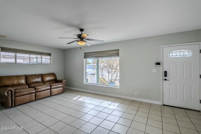 kitchen with decorative backsplash, appliances with stainless steel finishes, ceiling fan, and light tile patterned flooring