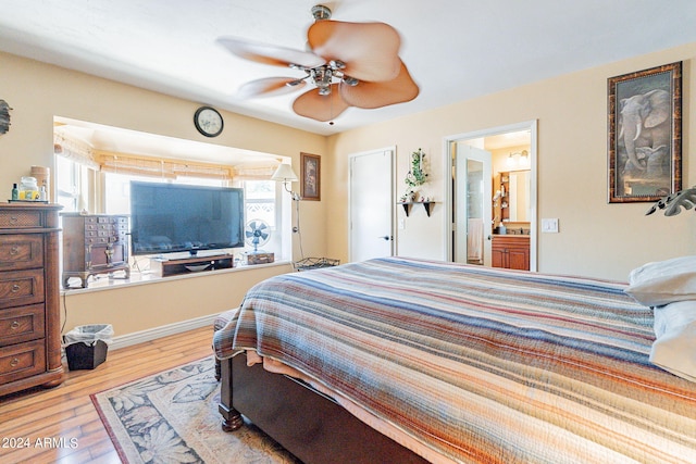 bedroom featuring ensuite bath, ceiling fan, and light wood-type flooring