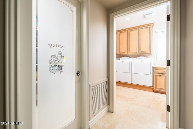 interior space featuring light tile patterned floors and washing machine and clothes dryer