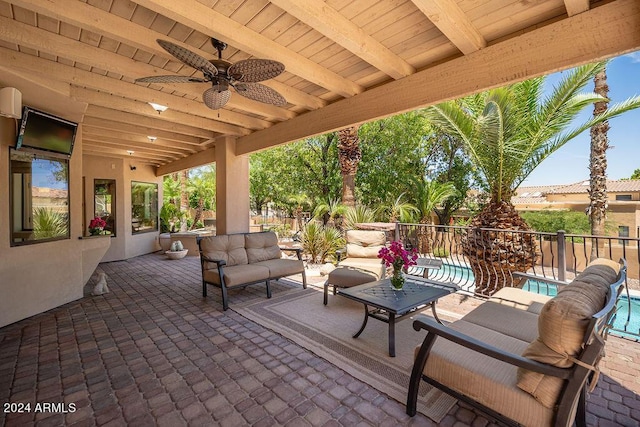 view of patio featuring ceiling fan, a fenced in pool, and an outdoor living space