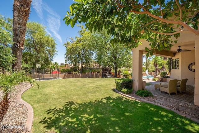 view of yard featuring ceiling fan, a fenced in pool, and a playground