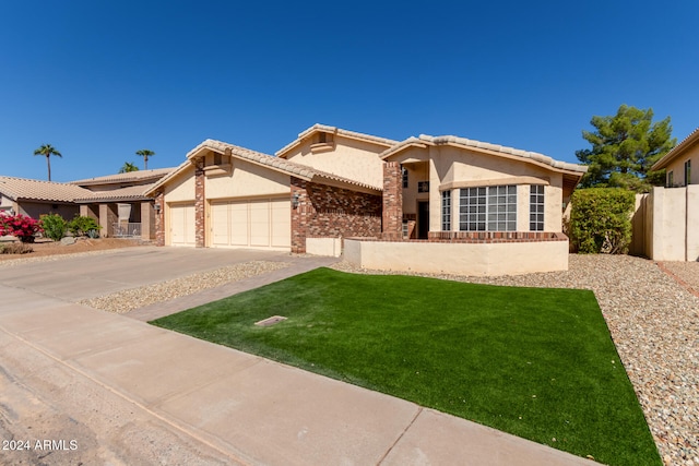 view of front of property featuring a front yard and a garage