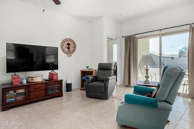 tiled living room with ceiling fan