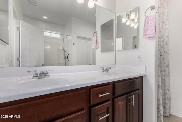 bathroom featuring walk in shower and vanity