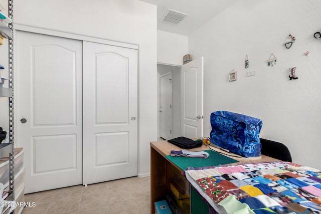 tiled bedroom featuring a closet