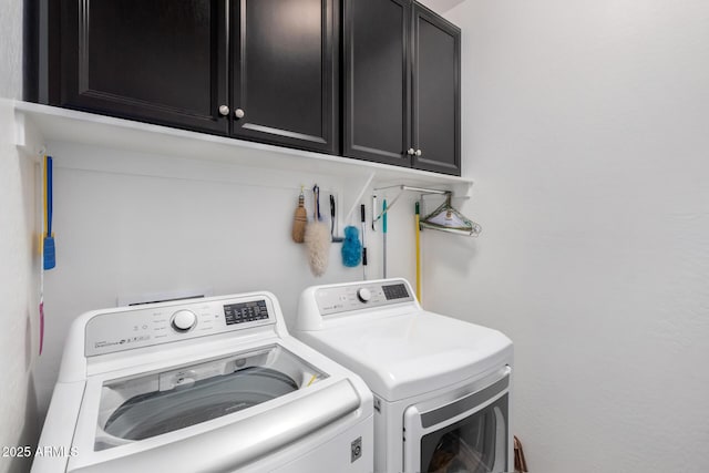 laundry room featuring cabinets and washing machine and clothes dryer