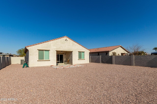 rear view of property with central AC and a patio area