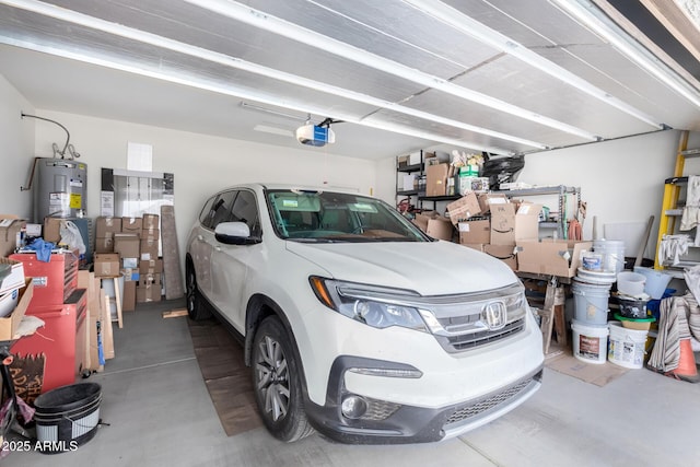 garage with a garage door opener and electric water heater