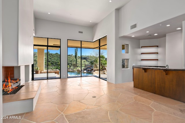 unfurnished living room featuring a high ceiling