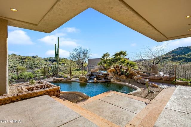 view of pool with a patio area and pool water feature