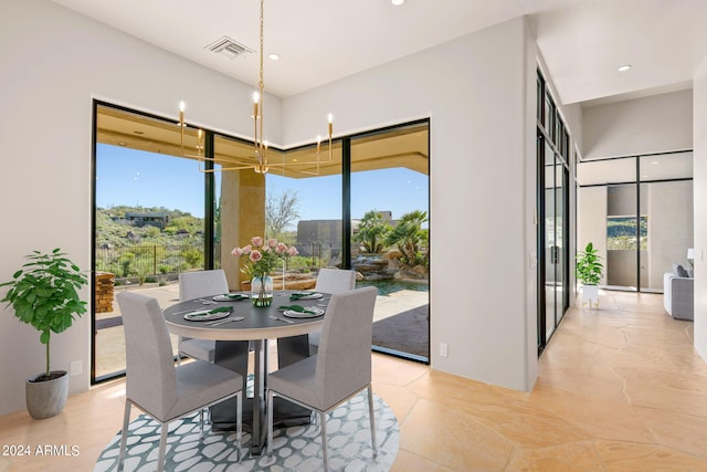 tiled dining room with a chandelier