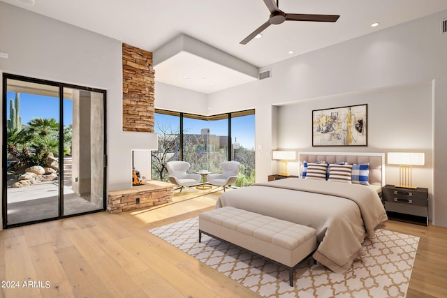 bedroom featuring access to exterior, ceiling fan, and light wood-type flooring