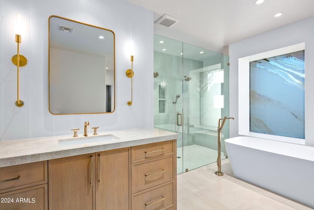 bathroom with walk in shower, vanity, and tile flooring