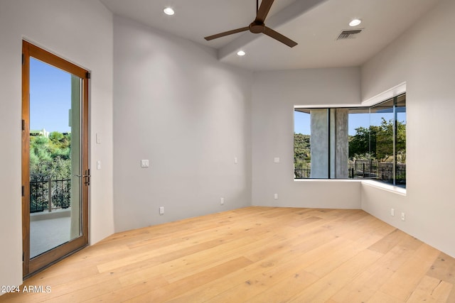 spare room with ceiling fan and light wood-type flooring