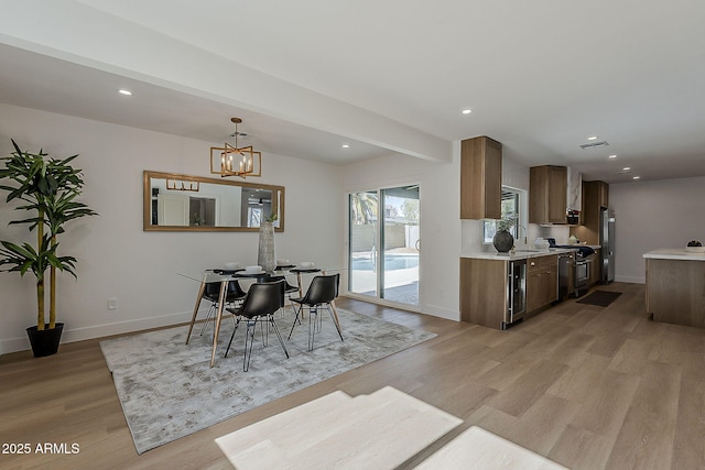 5028 W Shangri La Rd, Glendale, AZ 85304 - dining space with light wood-type flooring, recessed lighting, beverage cooler, and a chandelier