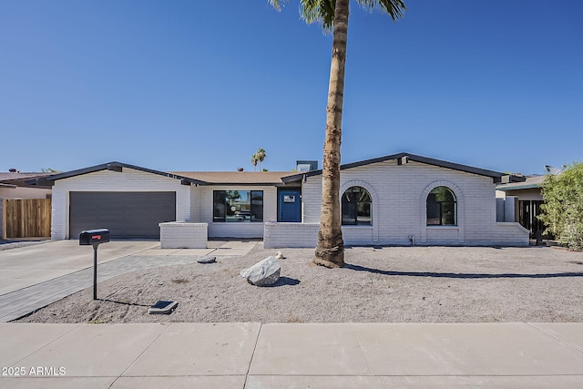 5028 W Shangri La Rd, Glendale, AZ 85304 - ranch-style house with concrete driveway, brick siding, and an attached garage