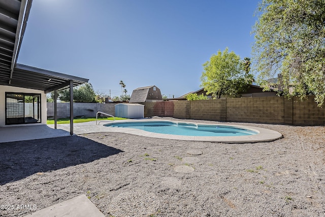 5028 W Shangri La Rd, Glendale, AZ 85304 - view of swimming pool featuring a fenced backyard, a patio area, and a storage shed