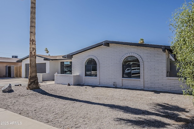 5028 W Shangri La Rd, Glendale, AZ 85304 - view of front of home featuring brick siding and a garage