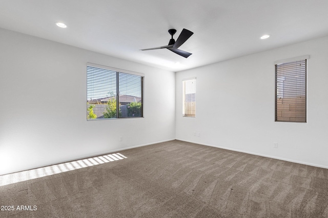 carpeted spare room featuring baseboards, a ceiling fan, and recessed lighting