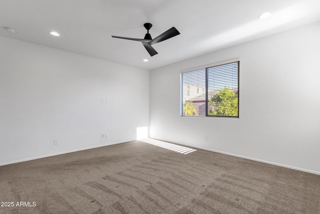 empty room with carpet flooring, ceiling fan, baseboards, and recessed lighting