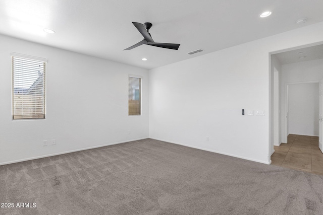 carpeted empty room featuring recessed lighting, visible vents, baseboards, and ceiling fan