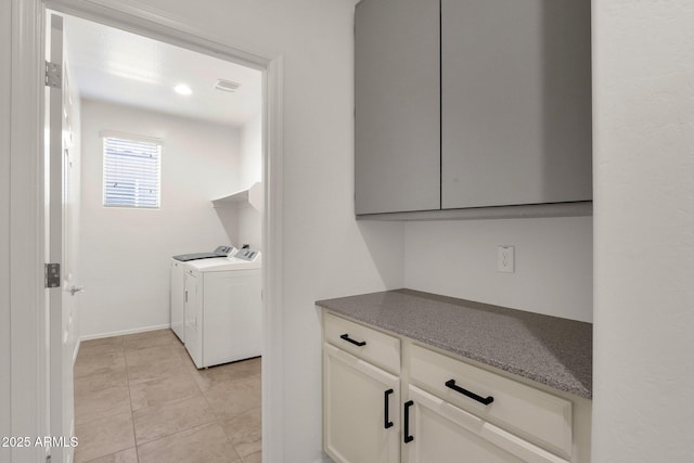laundry area featuring laundry area, washing machine and clothes dryer, and baseboards