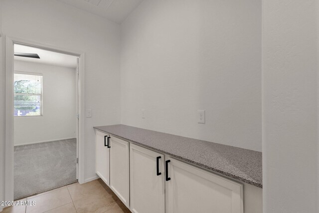 interior space featuring baseboards and tile patterned flooring