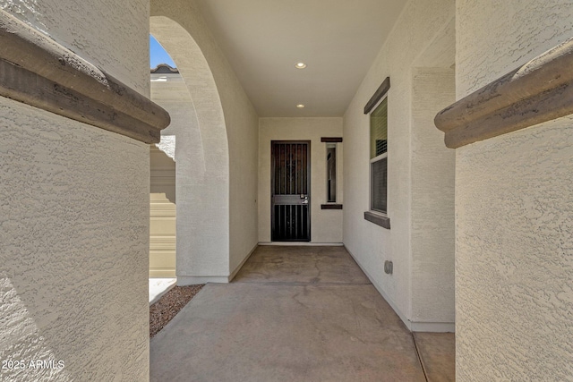 property entrance with stucco siding