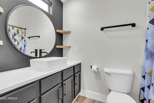 1350 S Greenfield Rd Unit 1166, Mesa, AZ 85206 - bathroom featuring baseboards, wood finished floors, toilet, and vanity