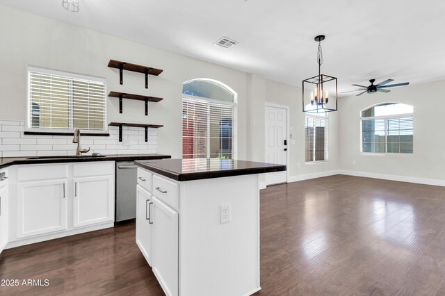 1350 S Greenfield Rd Unit 1166, Mesa, AZ 85206 - kitchen with a sink, dark countertops, stainless steel dishwasher, dark wood finished floors, and open shelves
