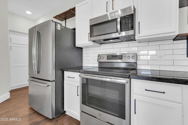 1350 S Greenfield Rd Unit 1166, Mesa, AZ 85206 - kitchen featuring appliances with stainless steel finishes, dark wood-style flooring, backsplash, white cabinetry, and dark stone counters