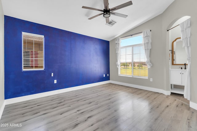 1350 S Greenfield Rd Unit 1166, Mesa, AZ 85206 - spare room with wood finished floors, a ceiling fan, vaulted ceiling, and baseboards