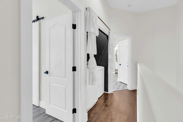 1350 S Greenfield Rd Unit 1166, Mesa, AZ 85206 - hall with washing machine and dryer, wood finished floors, and a barn door