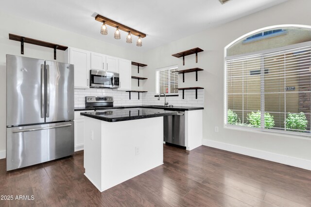 1350 S Greenfield Rd Unit 1166, Mesa, AZ 85206 - kitchen with appliances with stainless steel finishes, open shelves, a sink, dark countertops, and tasteful backsplash