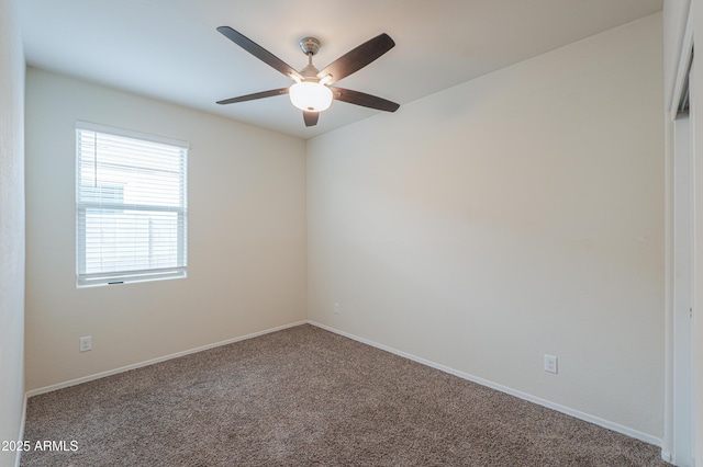 spare room featuring ceiling fan and carpet flooring