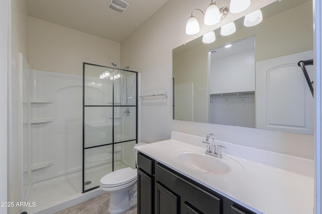 bathroom with vanity, toilet, and walk in shower