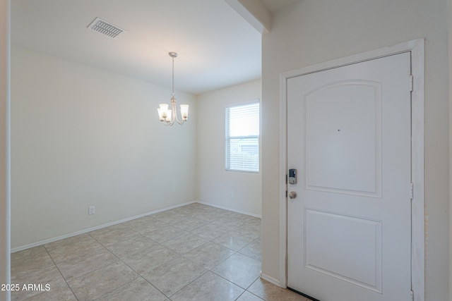 foyer with an inviting chandelier and light tile patterned floors