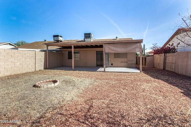 back of house with a patio area, cooling unit, and an outdoor fire pit