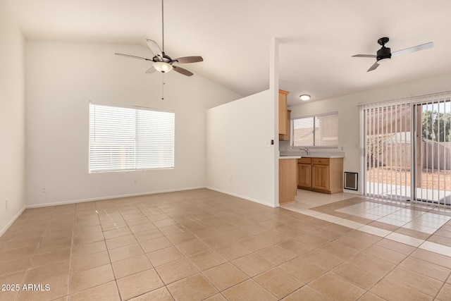 unfurnished living room with ceiling fan, light tile patterned floors, and lofted ceiling