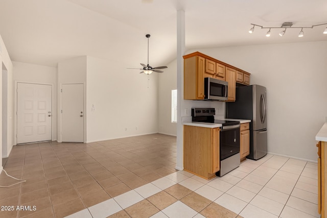 kitchen featuring ceiling fan, light tile patterned flooring, stainless steel appliances, and lofted ceiling