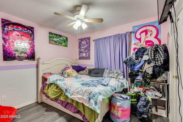 bedroom with wood-type flooring and ceiling fan