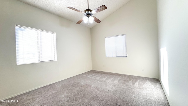 empty room featuring ceiling fan, carpet floors, a textured ceiling, and vaulted ceiling