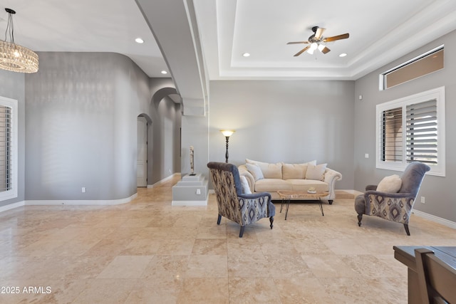 16246 E Gamble Ln, Scottsdale, AZ 85262 - living room featuring arched walkways, recessed lighting, a ceiling fan, and a chandelier