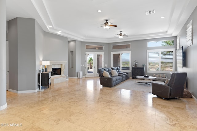 16246 E Gamble Ln, Scottsdale, AZ 85262 - living area featuring a ceiling fan, a raised ceiling, recessed lighting, a high end fireplace, and a high ceiling
