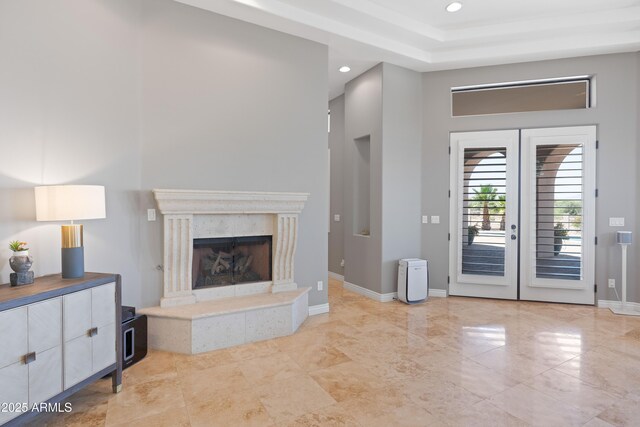 16246 E Gamble Ln, Scottsdale, AZ 85262 - unfurnished living room featuring recessed lighting, a premium fireplace, french doors, and a tray ceiling