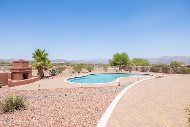 16246 E Gamble Ln, Scottsdale, AZ 85262 - view of swimming pool with exterior fireplace, a mountain view, and a patio area