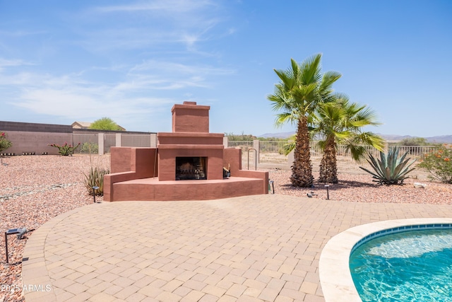 16246 E Gamble Ln, Scottsdale, AZ 85262 - view of pool featuring exterior fireplace, a fenced backyard, and a patio area