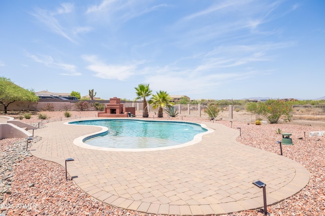 16246 E Gamble Ln, Scottsdale, AZ 85262 - view of swimming pool with a patio area, exterior fireplace, and a fenced backyard