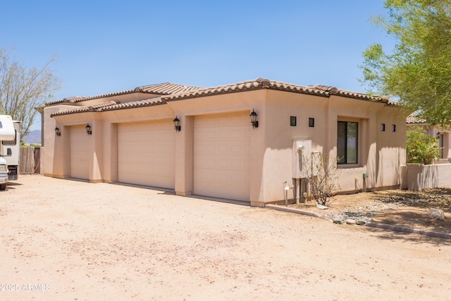 16246 E Gamble Ln, Scottsdale, AZ 85262 - view of side of property with stucco siding, a tiled roof, and an attached garage
